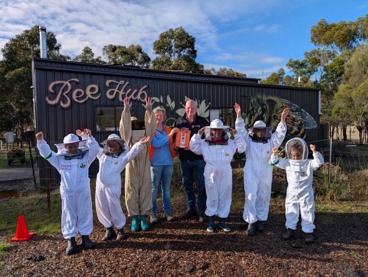 Junior Bee Keepers accepting their G5 AED Grant from St John