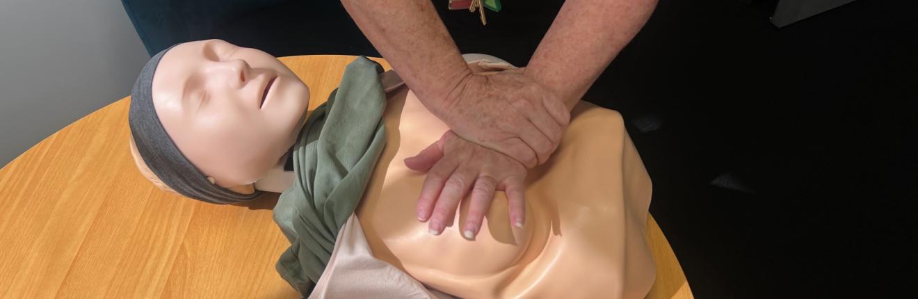 St John trainer performing CPR on a Womanikin
