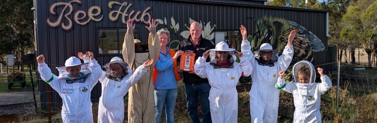 Junior Bee Keepers accepting their G5 AED Grant from St John 