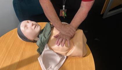 St John trainer performing CPR on a Womanikin