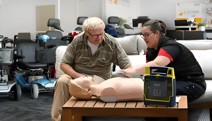 Older man talking to St John trainer about CPR