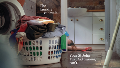 woman lying injured next to a pile of laundry