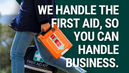 woman walking with a defib and first aid kit. Text says "We handle the first aid, so you can handle business