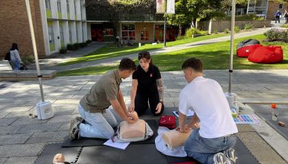 St John trainer teaching two people first CPR.