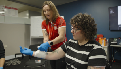 St John trainer demonstrating bandaging technique