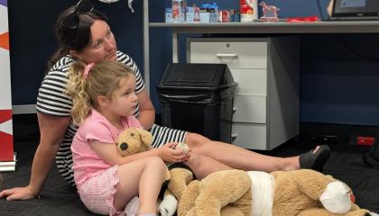 Parent sits beside the kid