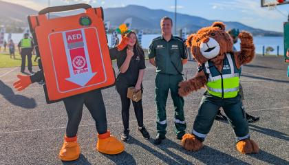An St John G5 AED mascot posing with St John staff