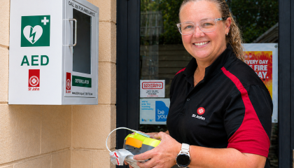 St John team member checking an AED 