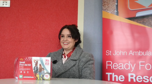 Krista sitting with a first aid kit