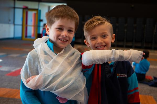 Two children in bandages at a First Aid in Schools lesson