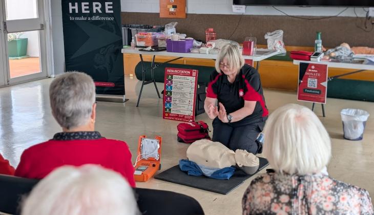 St John trainer demonstrating CPR techniques to older members of the community.