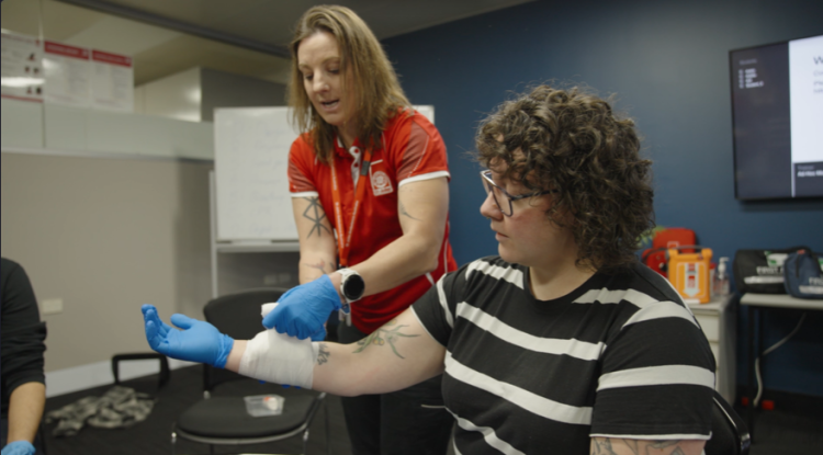 St John trainer demonstrating bandaging technique