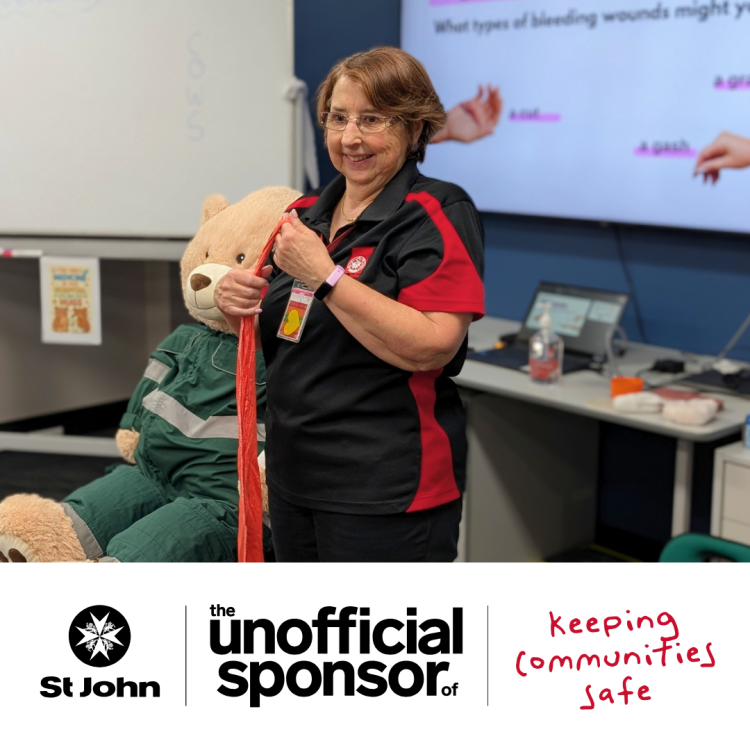 Picture od a volunteer teaching first aid to kids. text reads: The unofficial sponsor of keeping communities safe