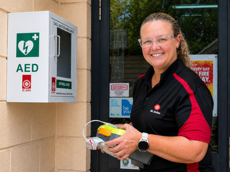 St John team member checking an AED 
