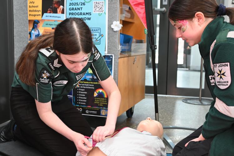 Youth program members learning CPR