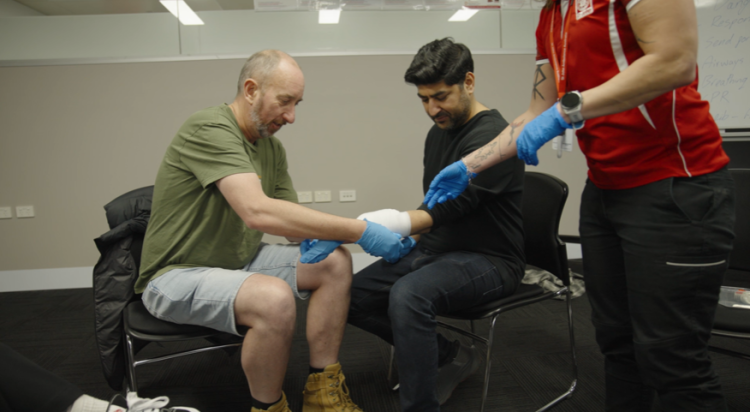 Trainer demonstrating bandaging