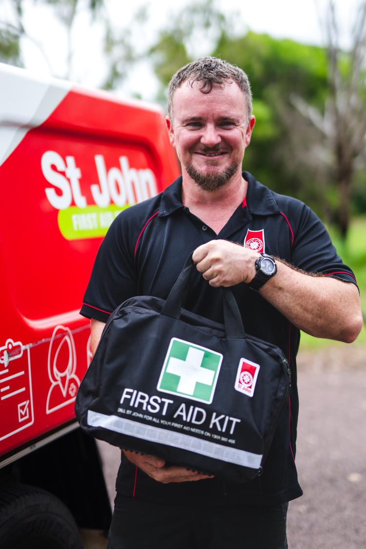 St John staff member holding a first aid kit